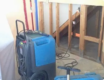 Dehumidifiers used to dry area.