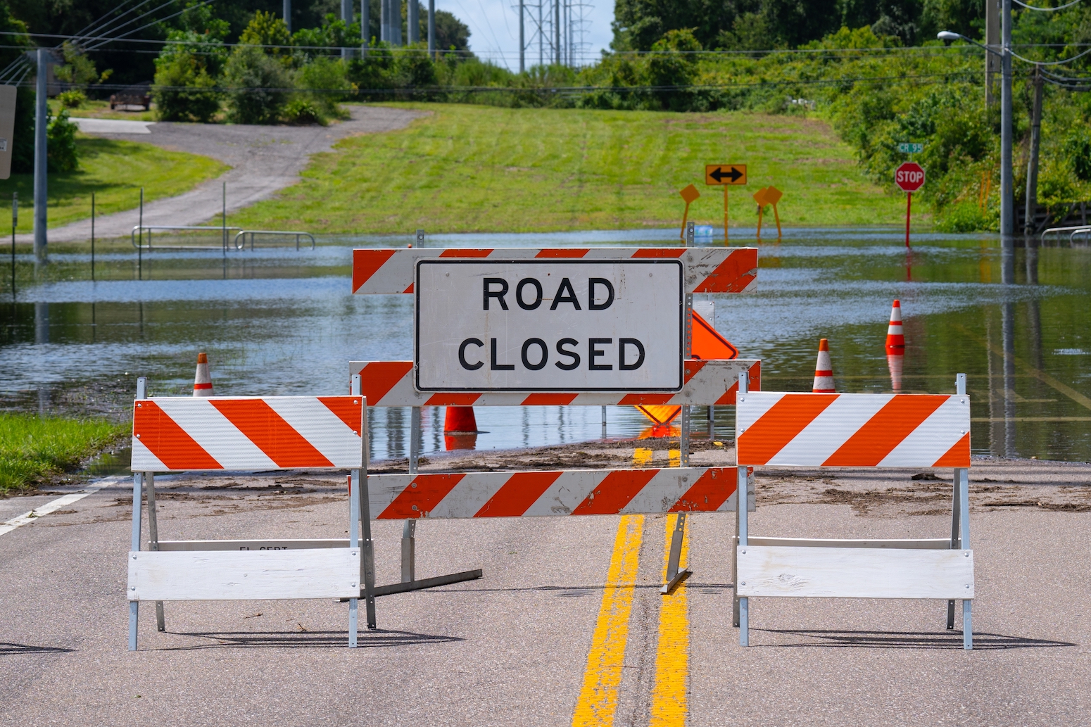Flood or flooding. Florida flooding after hurricane or tropical storm. Flooded streets, road or highway. Hurricane season. Road closed. Destroyed after rain. City underwater. United States of America